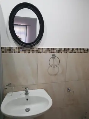 a bathroom with a sink and a mirror on the wall at Fama Lodge Rm13 in Cape Town