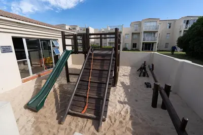 a playground with a slide in the sand at Nothing But View in Hermanus