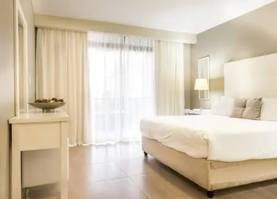 a bedroom with a white bed and a large window at Modern 2 bedroom with underground parking 1 mins from beach-205 La Cabina, Blouberg, Cape Town in Bloubergstrand