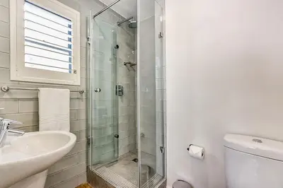 a bathroom with a shower and a sink and a toilet at Eikehoff 25 in Stellenbosch
