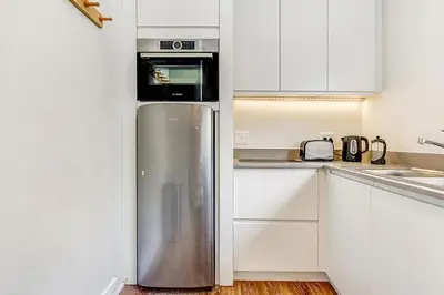 a kitchen with a stainless steel refrigerator and a microwave at Eikehoff 25 in Stellenbosch