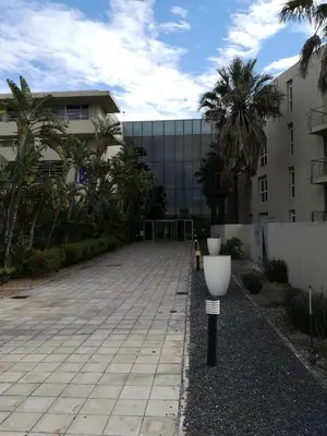 a parking lot in front of a building at A310 Lagoon Beach Apartment & Spa in Cape Town