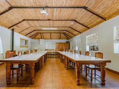a large room with a long table and chairs at Picardie Guest Farm in Paarl
