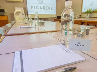 a bottle of water sitting on top of a table at Picardie Guest Farm in Paarl