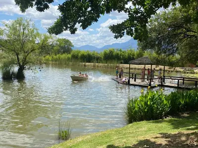a boat on a lake with people on it at Picardie Guest Farm in Paarl