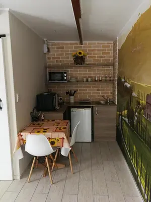 a kitchen with a table and chairs and a brick wall at Posto Al Sole - IL Bacio in Bellville
