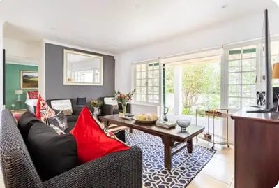 a living room with a couch and a table at Art House in Stellenbosch