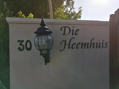 a street light on the side of a wall at Die Heemhuis in Rawsonville
