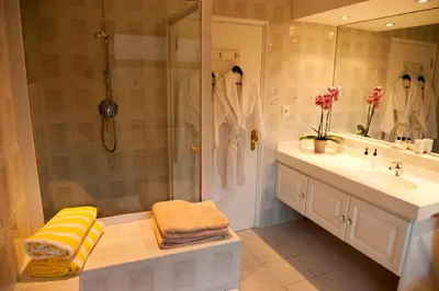 a bathroom with a shower and a sink at Easy Five Guest House in Somerset West