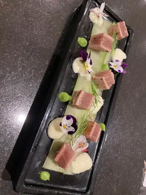 a plate of food with sushi on a table at Peach on Beach Boutique Guesthouse in Bloubergstrand