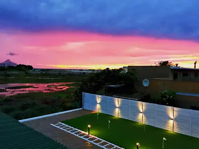a view of a sunset from the roof of a house at Peach on Beach Boutique Guesthouse in Bloubergstrand