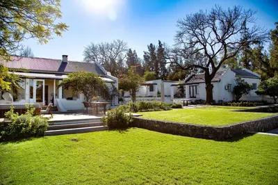a house with a yard with a retaining wall at Tempel Wines in Paarl