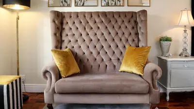 a chair with two pillows on it in a room at Daisy Place in Franschhoek