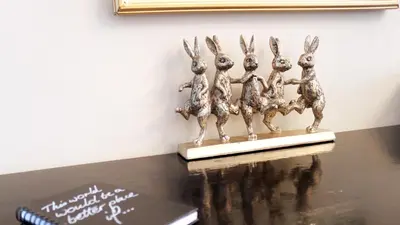 a bronze statue of four rabbits on a table at Daisy Place in Franschhoek