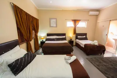 a hotel room with two beds and a window at Ramasibi Guest Services in Panorama