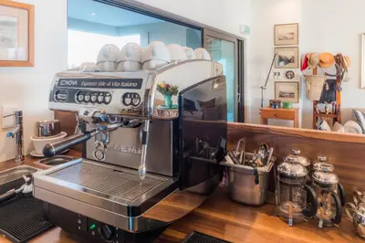 a kitchen with a coffee machine on a counter at Schulphoek Seafront Boutique Hotel in Hermanus