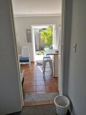 an open door to a kitchen with a table and chairs at On Cloud 9 in Hermanus