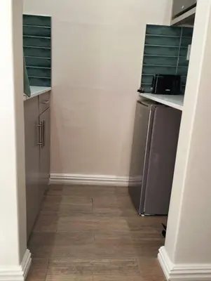 a kitchen with stainless steel appliances and wooden floors at Panorama Self Catering 2 in Panorama