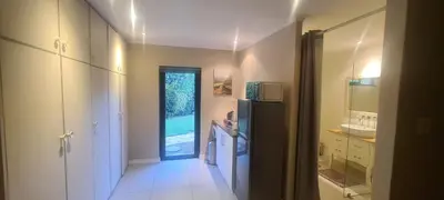 a kitchen with a black refrigerator and a sink at Guinea Vine in Stellenbosch