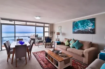 a living room with a couch and a table at Blakes Terrace 903 in Strand
