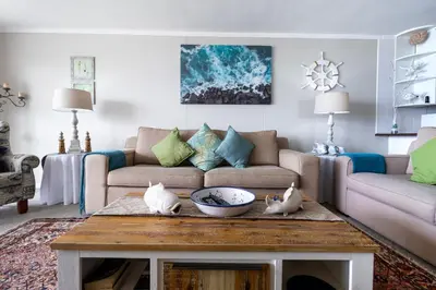 a living room with a couch and a table at Blakes Terrace 903 in Strand