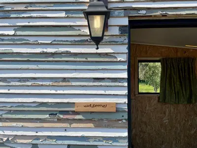 a wooden sign on the side of a building at UnderHill Farm in Klipkraal