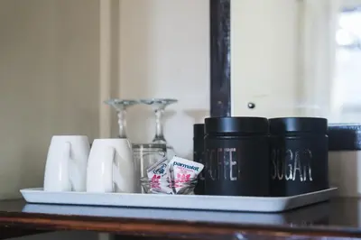 a tray with cups and other items on a table at Be My Guest Lodge in Bloubergstrand