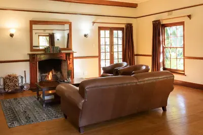 a living room with a couch and a fireplace at The Country Guesthouse in Stellenbosch