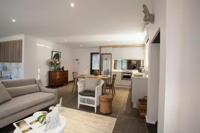 a living room and kitchen with a couch and a table at Mont Angelis in Stellenbosch