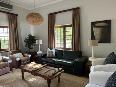 a living room with a couch and a coffee table at Hartebeeskraal House in Paarl