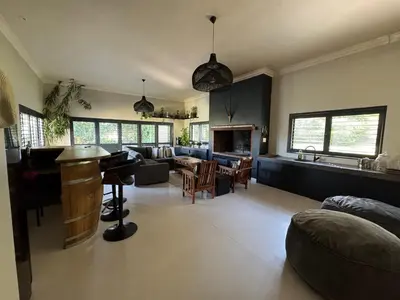 a large living room with a couch and a table at Hartebeeskraal House in Paarl