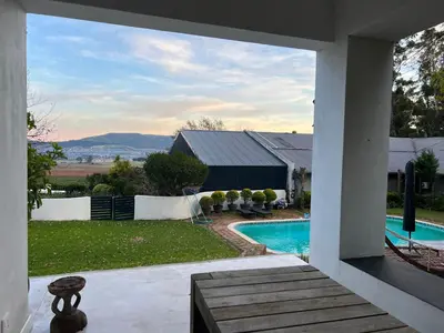 a view of a swimming pool from a house at Hartebeeskraal House in Paarl