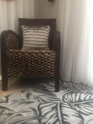 a chair with a pillow on top of a carpet at Little Scotia in Cape Town