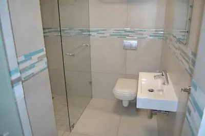 a bathroom with a toilet and a sink at Columbine Place in Durbanville