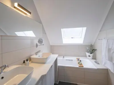 a bathroom with two sinks and a tub and a mirror at Sanddrif Stellenbosch Guest Farm in Stellenbosch