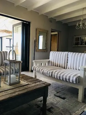 a living room with a couch and a coffee table at Pringle @ 865 Jally in Pringle Bay