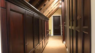 a hallway with wood cabinets and a hallway with a door at Ridgemor Villa in Somerset West