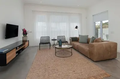 a living room with a couch and a tv at Perla in Hermanus