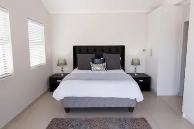 a bedroom with a large bed with two night stands at MLMK Property 30 in Richwood