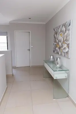 a white room with a table and a painting on the wall at MLMK Property 30 in Richwood