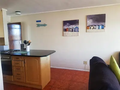 a kitchen with a counter and a stove top oven at Zeezicht 303 in Bloubergstrand