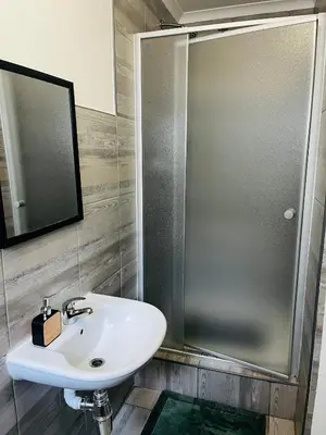 a bathroom with a sink and a shower at Modern secure apartment in Strand - Little Greece in Strand