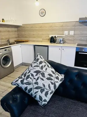 a couch with a pillow on it in a kitchen at Modern secure apartment in Strand - Little Greece in Strand