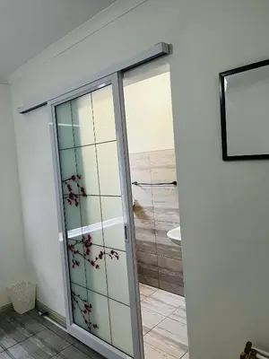 a bathroom with a glass door with a shower at Modern secure apartment in Strand - Little Greece in Strand