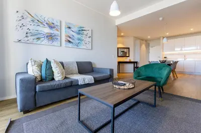 a living room with a couch and a table at Axis Luxury Apartments by Century City Hotels in Cape Town