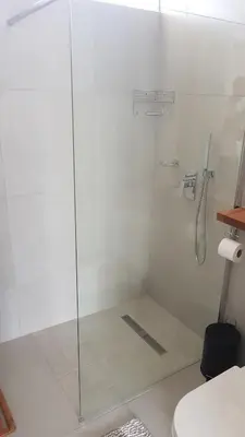 a shower with a glass door in a bathroom at 604 St Tropez in Strand