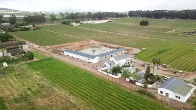 an aerial view of a large white building in a field at Middelplaas Paarl Guesthouse in Paarl