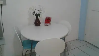 a white table with a vase on top of it at 36 Df Strauss Street in Kleinmond