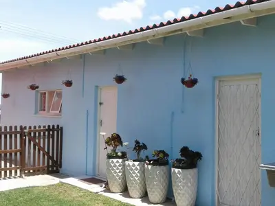 a blue house with potted plants in front of it at 36 Df Strauss Street in Kleinmond