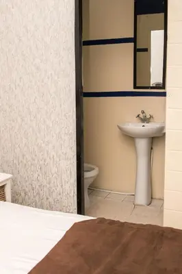 a bathroom with a sink and a toilet at Mauya Guesthouse in Kuilsrivier